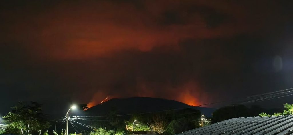 Bomberos de El Zulia controlan una línea de fuego sobre una ladera.